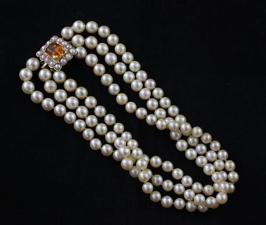 A 1980s triple strand cultured pearl choker necklace with 9ct gold, citrine and cultured pearl clasp, 13in.